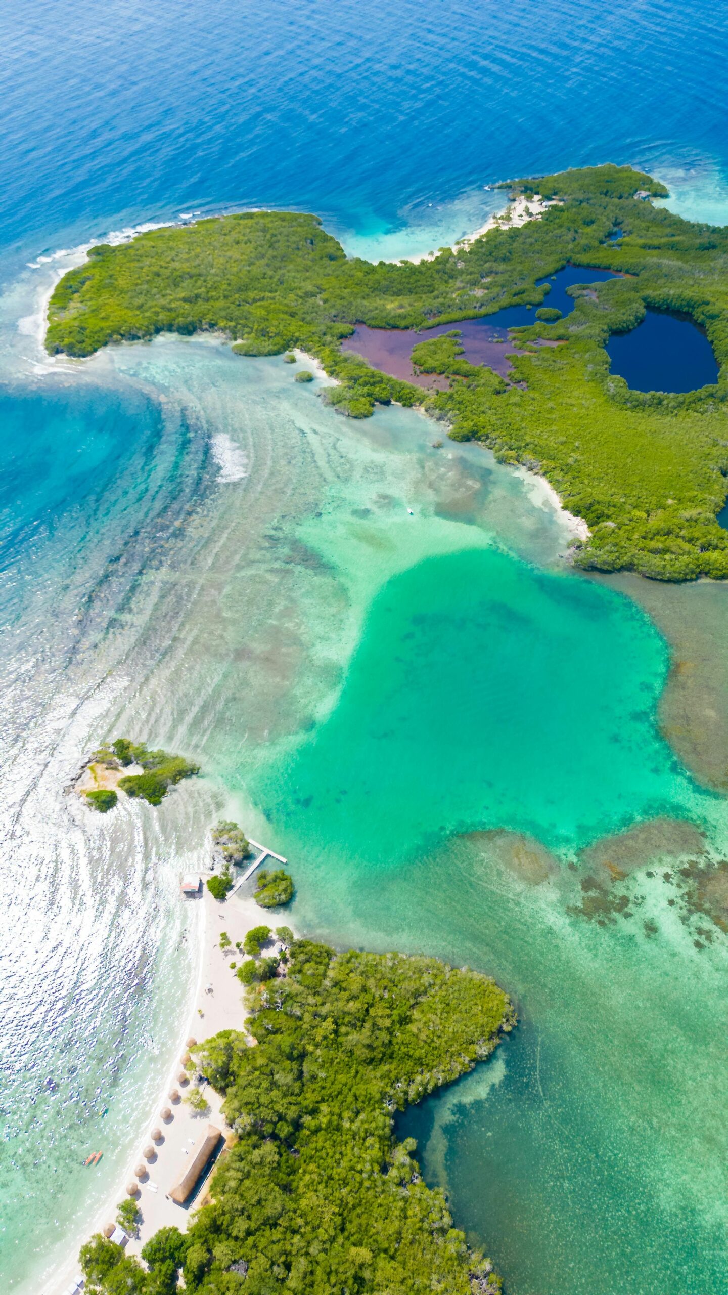 Vertical aerial view of a blue lagoon on a bright sunny day